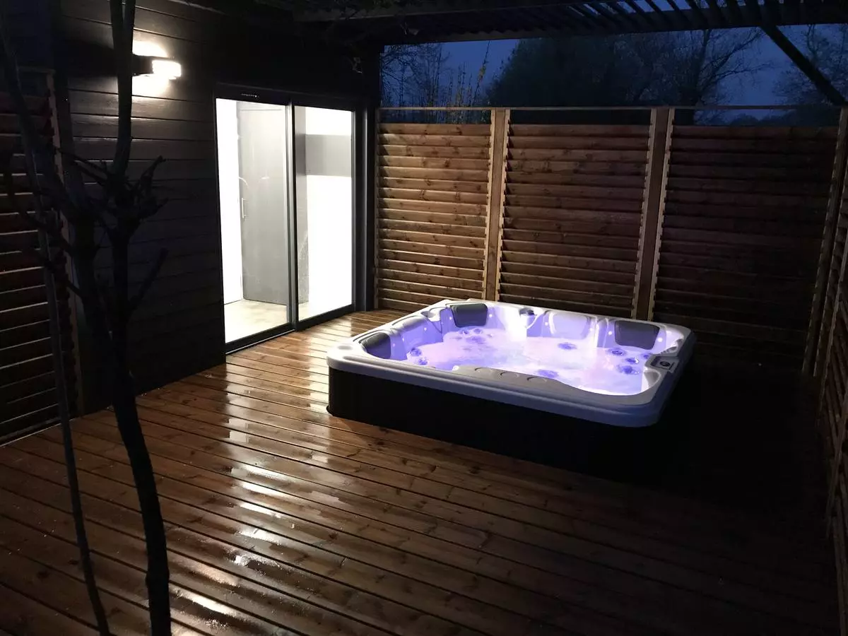 Jacuzzi illuminated at night at Les Bruyères campsite in Carnac