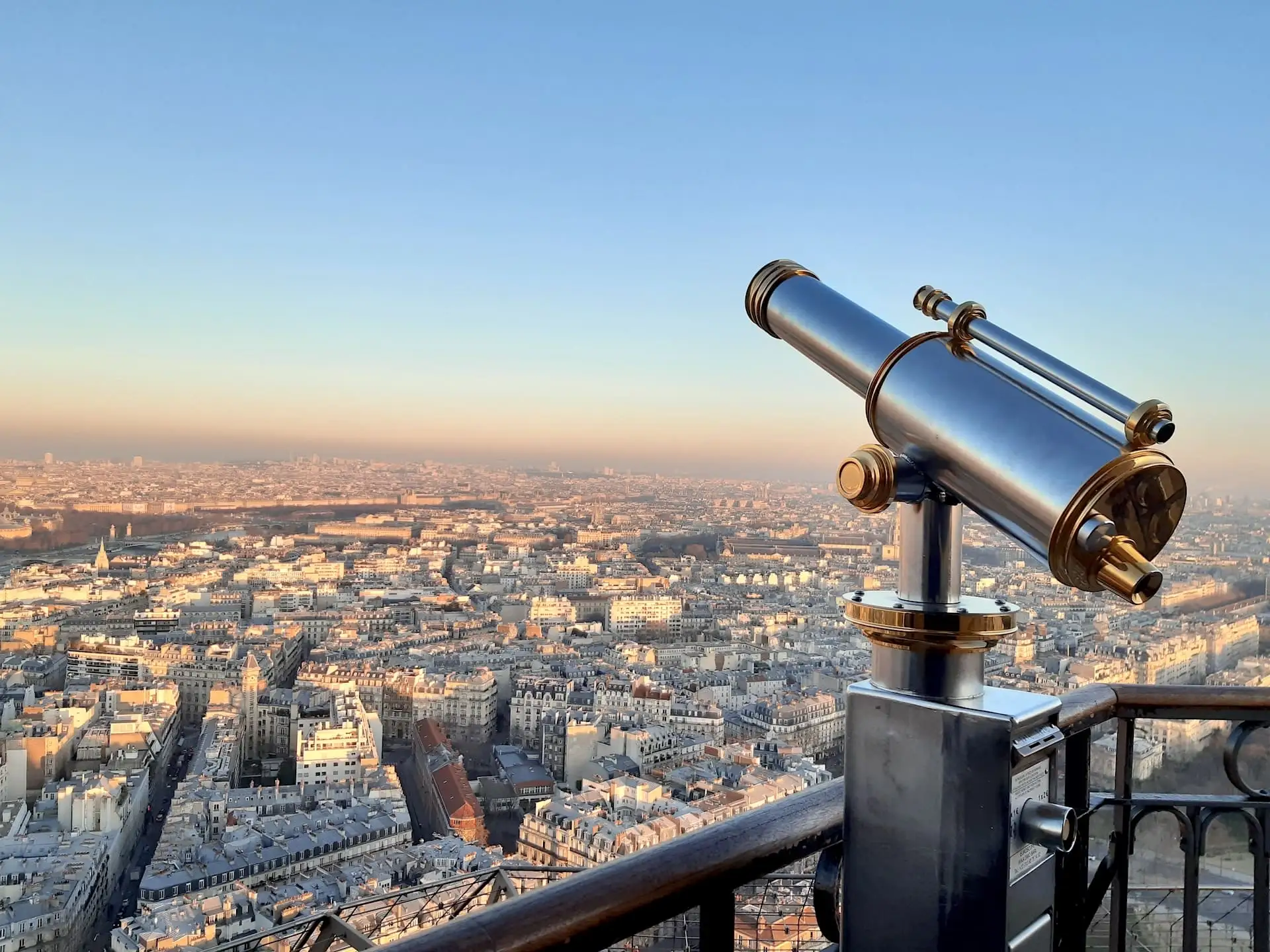 Tourist telescopes with a view of Paris from the Eiffel Tower