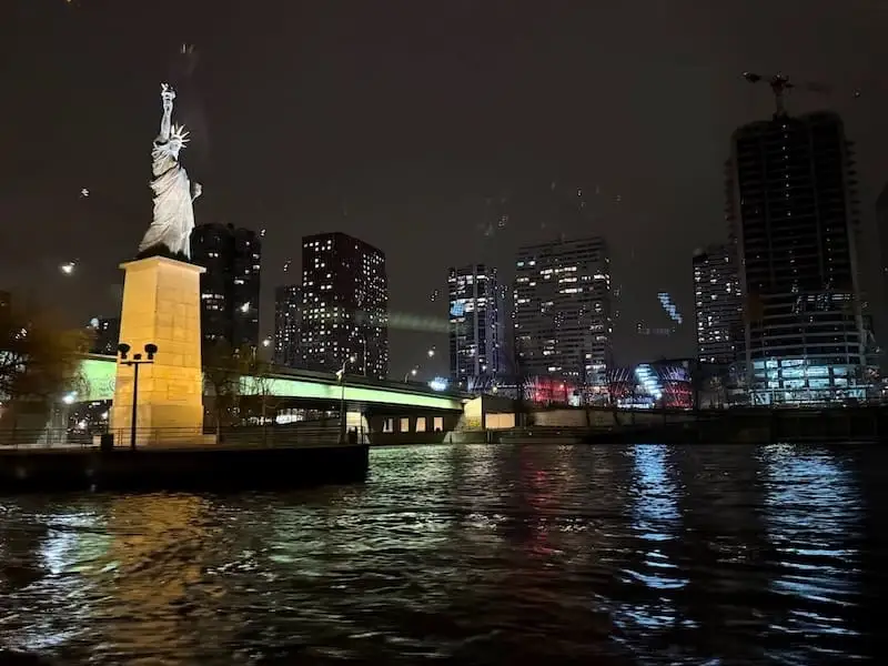 Small French Statue of Liberty at night French Statue of Liberty on the Seine at night