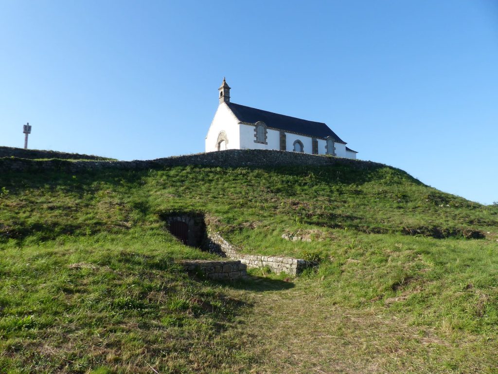 Carnac Tumulus on a Green Hill with a White Chapel